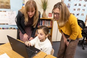 Idaho STEM Action Center executive director Caty Solace and Boise Mayor Lauren McLean learns about coding from third-grader Amaya Mateo