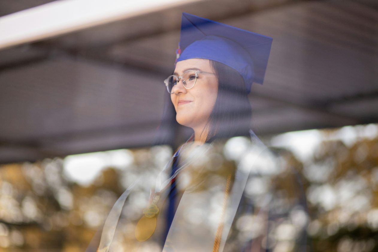 graduate looking out a window