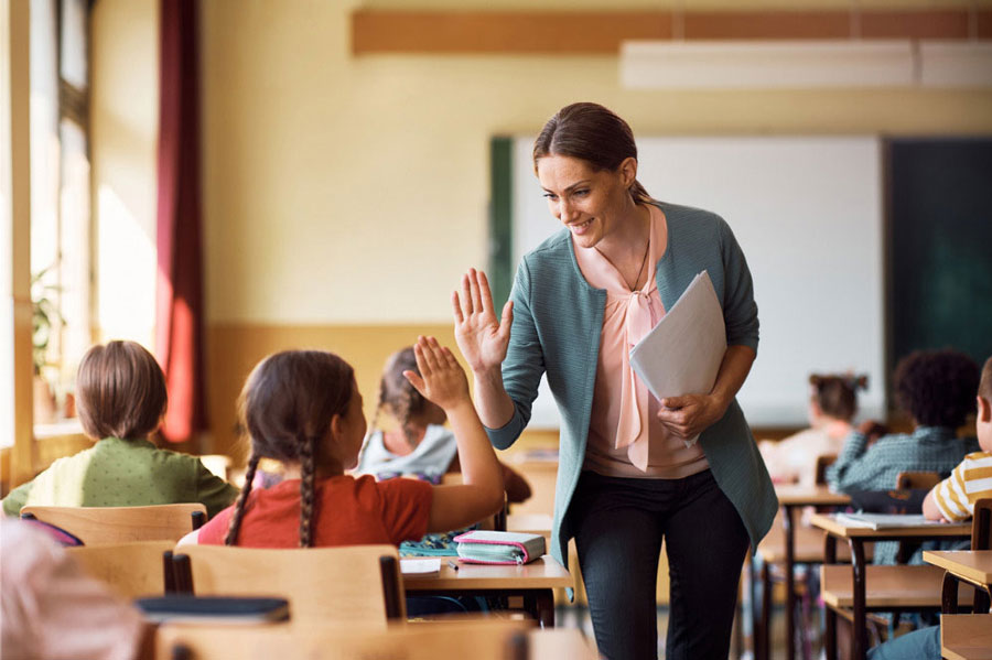 woman teacher giving a student a high five